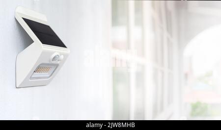 Small solar powered led light with motion sensor. Stock Photo