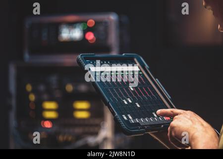 Remote control and sound settings from the tablet. Stock Photo