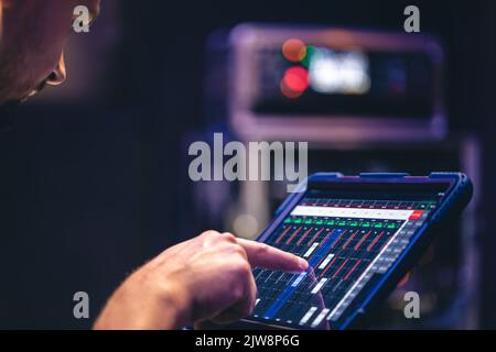 Remote control and sound settings from the tablet. Stock Photo