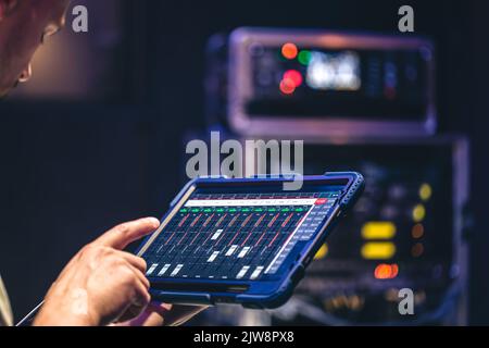 Remote control and sound settings from the tablet. Stock Photo