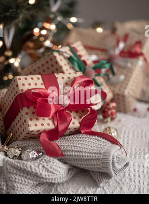 Festive gift boxes under the Christmas tree, close-up. Stock Photo