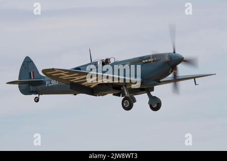 Supermarine spitfire PL983 of the Aircraft Restoration Company landing on runway 24 at the Duxford Summer Airshow 23rd July 2022 Stock Photo