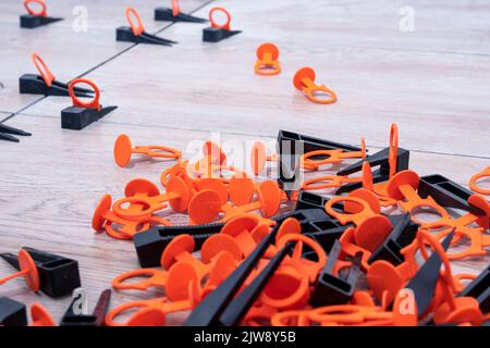 Tile leveling system with plastic clips and wedges. repair school Stock Photo