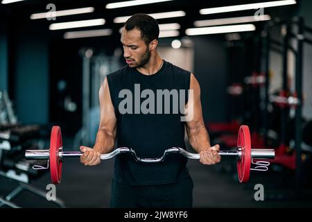 Portrait Of Athletic Black Man With Barbell In Hands Exercising At Gym Stock Photo