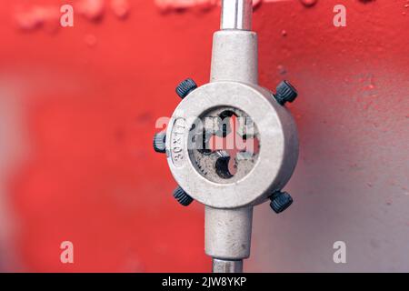 a die for threading on a shelf in the workshop Stock Photo