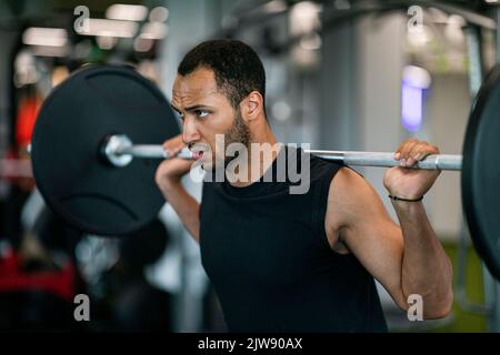 Handsome Black Male Bodybuilder Doing Weight Lifting Workout At Gym Stock Photo