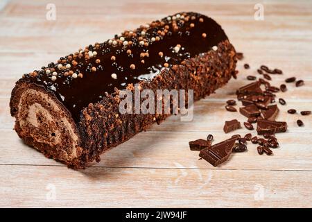 swiss chocolate roll, roll, cream roll, swiss log. Sold in a supermarket. Plastic box. Biscuit, jam and cream. Stock Photo