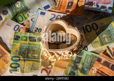 Background of euro bills  and Turkish Lira coins in a heart shaped bowl. Fragment part of euro money Stock Photo