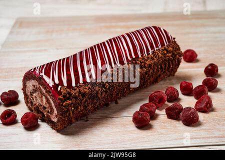 swiss chocolate roll, roll, cream roll, swiss log. Sold in a supermarket. Plastic box. Biscuit, jam and cream. Stock Photo