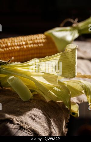 Cobs of sweet corn on a wooden table Stock Photo