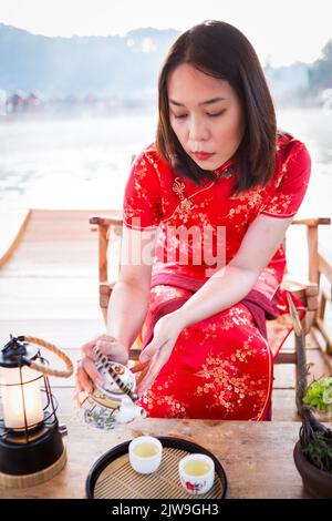 asian lady portrait relax in Chinese style long dress or vietnam contemporary accessories happy on location morning Stock Photo