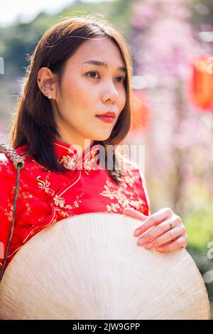 asian lady portrait relax in Chinese style long dress or vietnam contemporary accessories happy on location morning Stock Photo