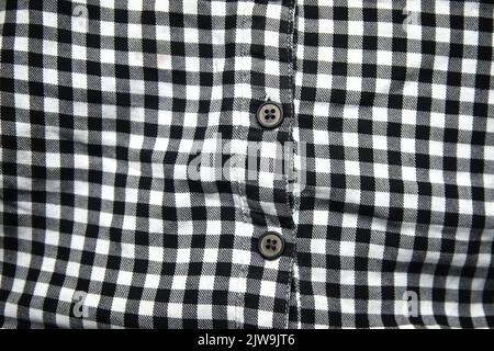 Defocus black and white shirt. Gingham tablecloth back pattern. Fragment of a wrinkled squared black and white shirt cloth fabric as a background text Stock Photo