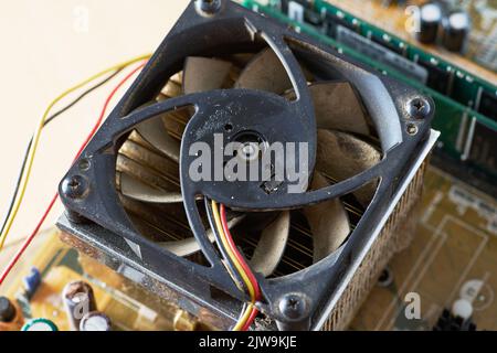 A thick layer of dust covers the internal electronic components of the computer. Stock Photo