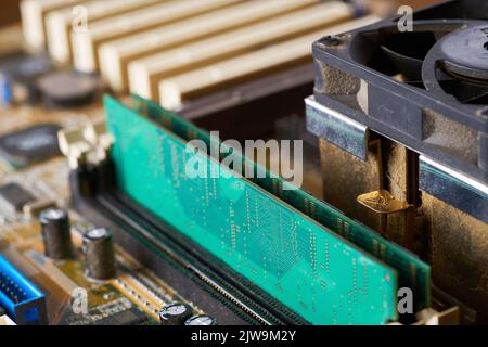 Old motherboard covered in dust and dirt. Close-up. Stock Photo