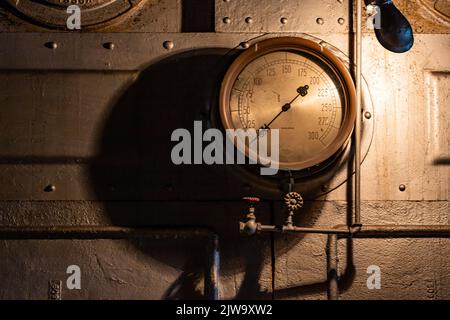 Seattle, WA. USA -08-27-2022: Temperature gage along wall in control room at Georgetown Steam Plant Stock Photo
