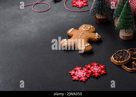 Christmas decorations and gingerbreads on a dark concrete table