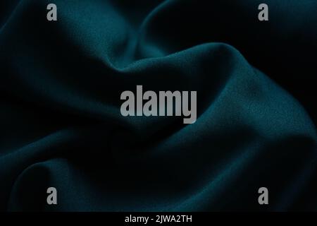 Closeup wrinkled green jersey, soft fabric background. Stock Photo