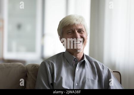 Happy senior man talking on video call from home Stock Photo