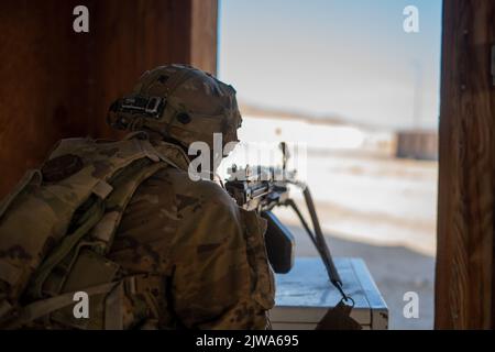 U.S. Soldiers  assigned to 1st Battalion, 63rd Armor Regiment, 2nd Armored Brigade Combat Team, 1st Infantry Division defend their positions from a simulated enemy counter attack during Decisive Action Rotation 22-09 at the National Training Center, Fort Irwin, Calif., Aug 11th, 2022. (U.S. Army photo by Cpl. Dominic Acuna, Operations Group, National Training Center) Stock Photo