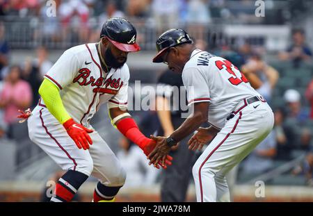 Atlanta, GA, USA. 04th Sep, 2022. Atlanta Braves outfielder Marcell Ozuna (left) slaps hands with third base coach Ron Washington (right) after hitting a fifth inning home run during a MLB game against the Miami Marlins at Truist Park in Atlanta, GA. Austin McAfee/CSM/Alamy Live News Stock Photo