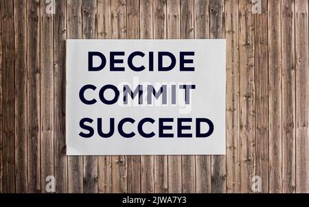 Conceptual hand writing showing DECIDE COMMIT SUCCEED on notepad and wooden background. Achievement of the goal. Reach your dreams. Stock Photo