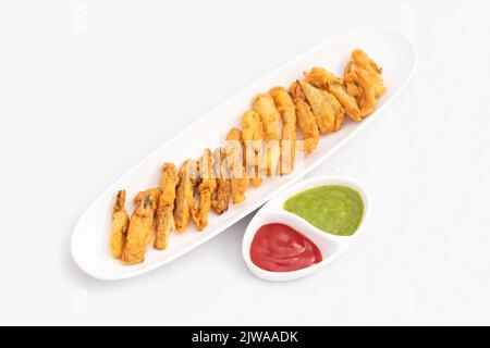 Indian Street Food Sliced Crispy Fried Potato Wedges Also Called Aloo Bhajji, Alu Bajji, Aaloo Pakoda or Pakora Made Of Bengal Gram Flour Besan Coat Stock Photo