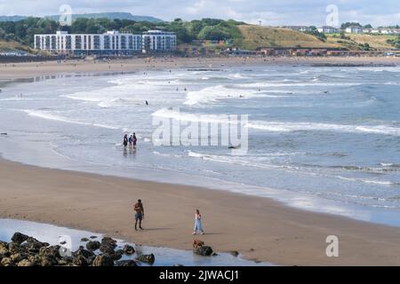 Scarborough, North Yorkshire, UK, September 1  2022 A summer's day view over Scarborough South Bay with holidaymakers enjoying the beach and sea. Stock Photo