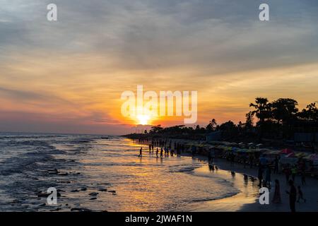 sunset landscape photo of Kuakata sea beach . evening sky reflected on wet sand . Stock Photo