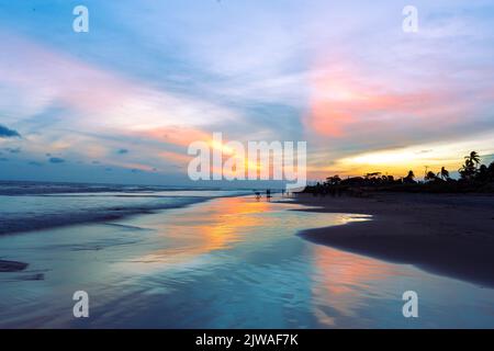 sunset landscape photo of Kuakata sea beach . evening sky reflected on wet sand . Stock Photo