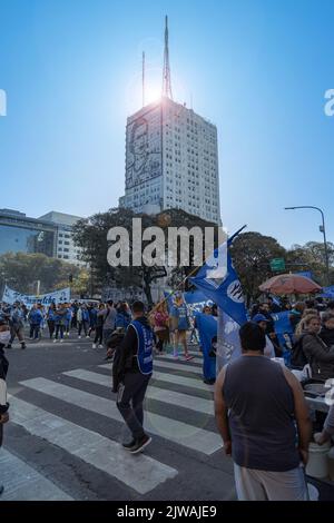 Buenos Aires, Argentina - September 2nd, 2022: Protesters march with flags in front of the Public Works building with the image of Eva Duarte de Peron Stock Photo