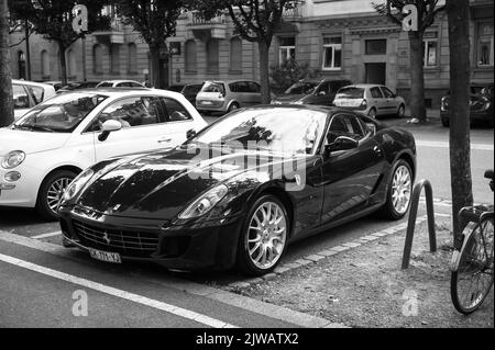 Paris, France - Jun 27, 2015: Monochrome image of black Ferrari car parked in city Stock Photo
