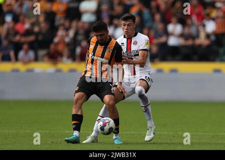 Hull, UK. 4th September, 2022. Lewis Coyle of Hull City battles for possession with Sheffield United's Anel Ahmedhodzic during the Sky Bet Championship match between Hull City and Sheffield United at the MKM Stadium, Kingston upon Hull on Sunday 4th September 2022. (Credit: Mark Fletcher | MI News) Credit: MI News & Sport /Alamy Live News Stock Photo