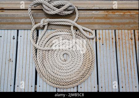 Coiled marine ropes on the quayside in Marigot, the capital of the French side of the Caribbean island of St Martin Stock Photo