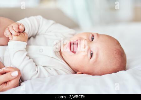 Giggles, cuddles and snuggles. an adorable baby boy bonding with his mother at home. Stock Photo