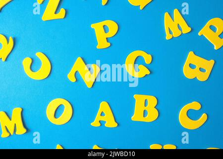 Colorful letters of the alphabet on a blue background. Elementary school or preschool. learning through play. Stock Photo