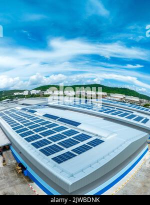 Top view Solar Cell on Warehouse Factory. Solor photo voltaic panels system power or Solar Cell on industrial building roof for producing green ecolog Stock Photo