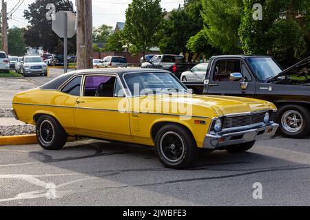 A yellow 1969 Chevrolet Nova sedan on display at a car show in Auburn, Indiana, USA. Stock Photo