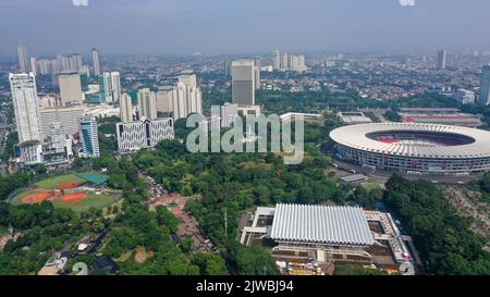 Beautiful scenery of Senayan Stadium under blue sky with Jakarta cityscape background Stock Photo