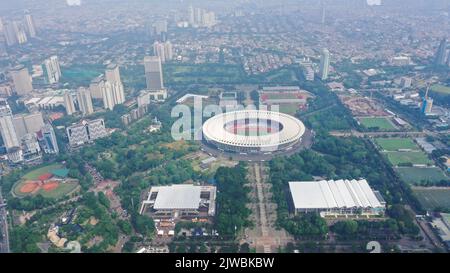 Beautiful scenery of Senayan Stadium under blue sky with Jakarta cityscape background Stock Photo