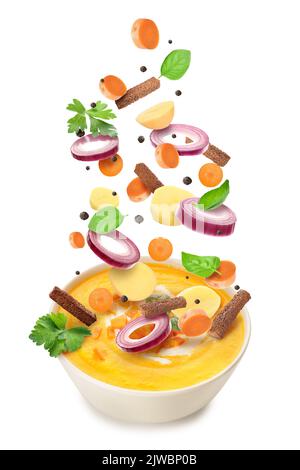 Bowl of tasty carrot cream soup and ingredients on white background Stock Photo