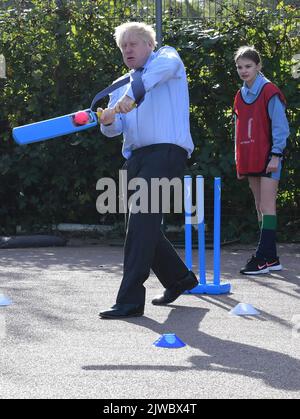 File photo dated 28/09/2020 of Prime Minister Boris Johnson takes part in a game of cricket during a sports lesson at Ruislip High School in his local constituency of Uxbridge, west London. Either Liz Truss or Rishi Sunak will be declared as the new leader of the Conservative Party, and successor to Prime Minister Boris Johnson, on Monday afternoon. The incoming PM will face a daunting set of challenges including an energy crisis, soaring inflation, further strike action and the ongoing war in Ukraine.Issue date: Monday September 5, 2022. Stock Photo