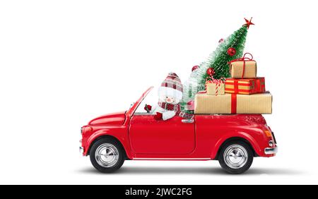 Snowman driving red car with christmas gifts and christmas tree isolated on a white background. Stock Photo