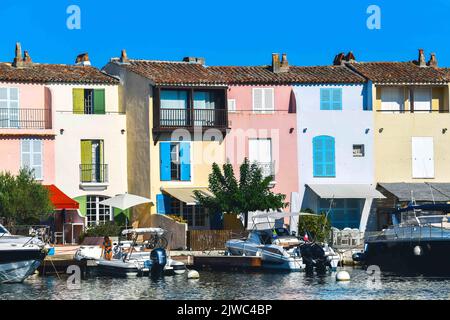 A view of Port Grimaud, south of France in September 4, 2022. Port Grimaud is a seaside town that forms part of the commune of Grimaud in the Var department of the Provence-Alpes-Côte d'Azur region in southeastern France. It is located seven km (4.3 miles) west of Saint-Tropez and seven km (4.3 miles) southwest of Sainte-Maxime. This seaside town was created by architect François Spoerry in the 1960s by modifying the marshes of the river Giscle on the bay of Saint-Tropez. Built with channels in a Venetian manner, but with French 'fisherman'-style houses resembling those in Saint-Tropez, Spoerr Stock Photo