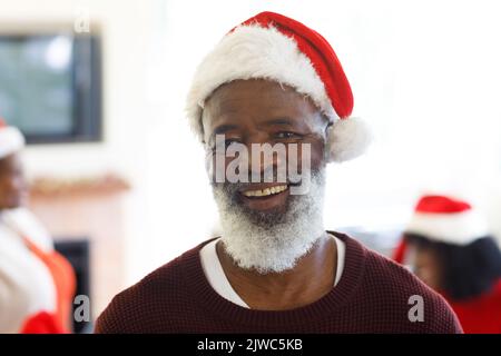 Portrait of senior african american man wearing santa hat Stock Photo