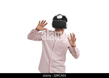 Young peruvian man laughing using virtual reality headset, isolated. Stock Photo