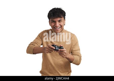 Young peruvian man playing video games with a joystick, isolated. Stock Photo