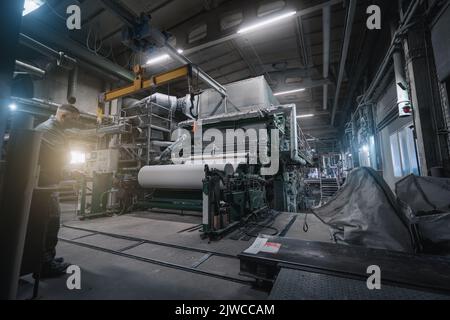 Paper production machine in wastepaper recycling factory. Paper and pulp mill. Stock Photo