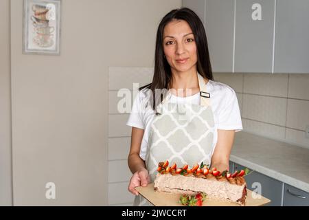 Young cook cooking cakes in the kitchen. Pastry chef Stock Photo