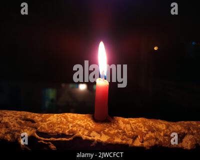 a candal flame is lightning in very dark night Stock Photo